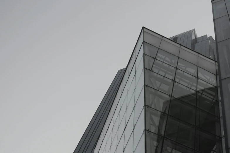 an airplane flying in the sky above a very tall building