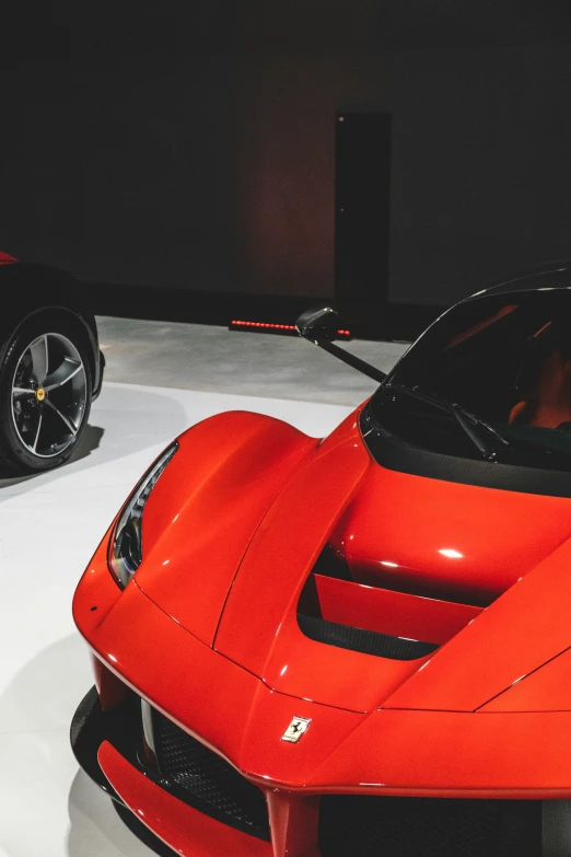 a red sports car is on display at the motor museum