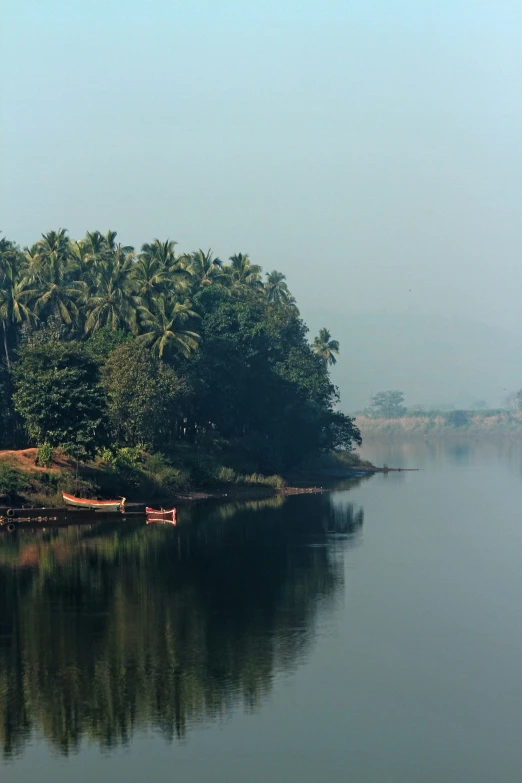 a lone boat is sitting in the middle of a lake