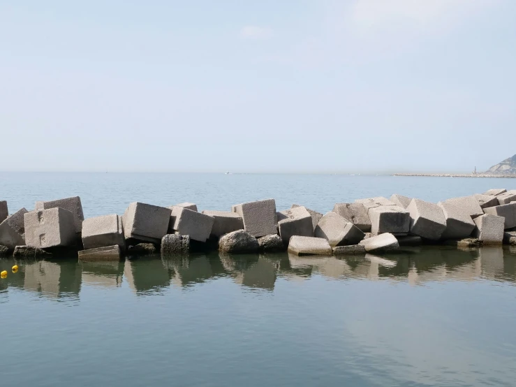 the pier is built from concrete blocks into the water