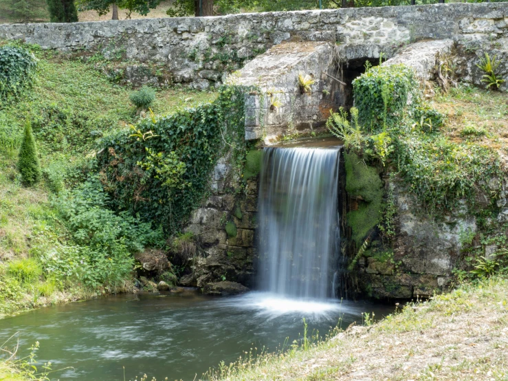 a waterfall with a couple of bricks over it