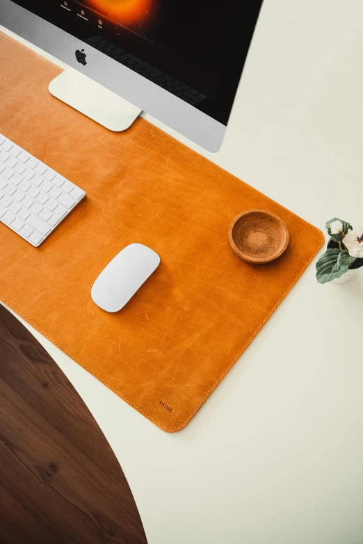 a white desktop on a table near a keyboard