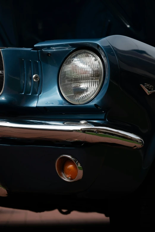 an old style car's front view mirror showing the grill lights