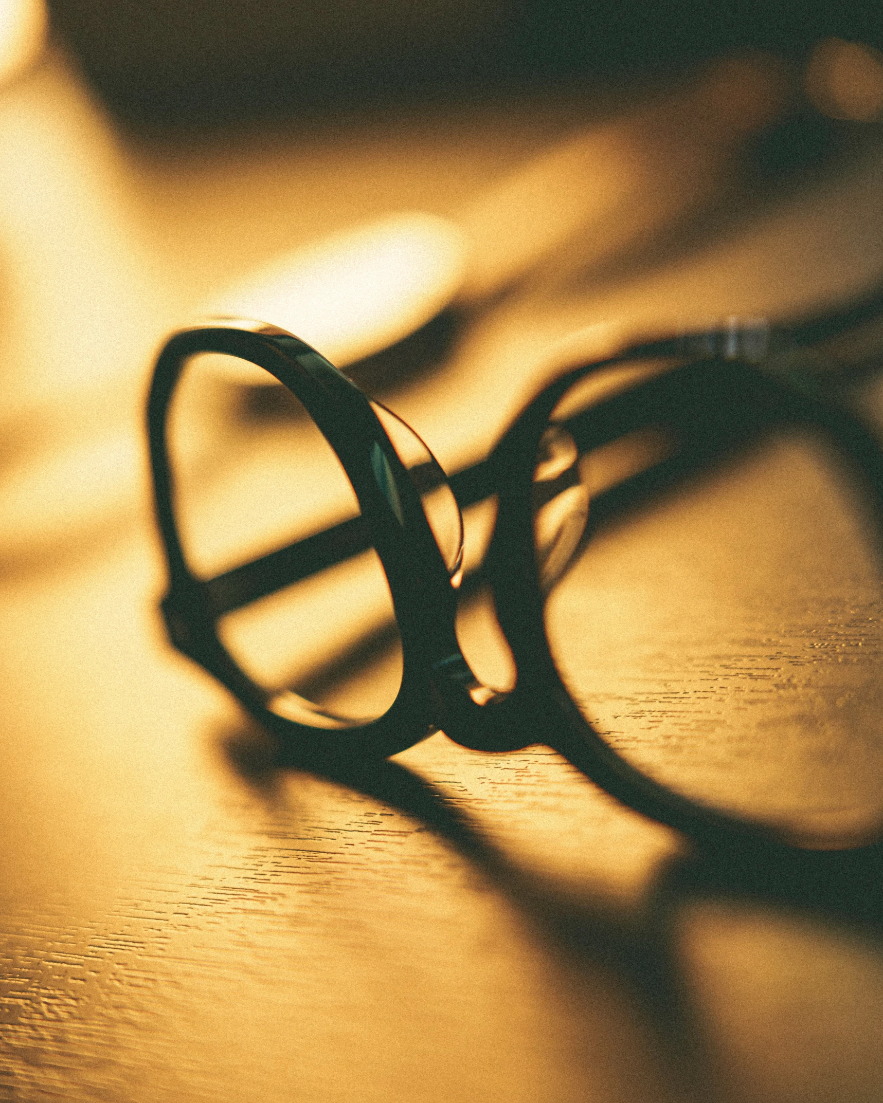 a pair of glasses is laying on top of a table