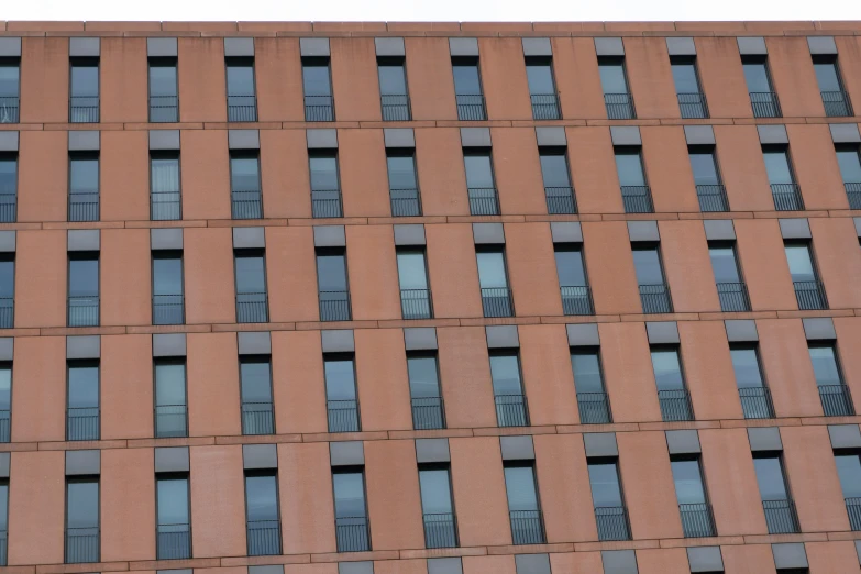 a clock that is standing in front of a building