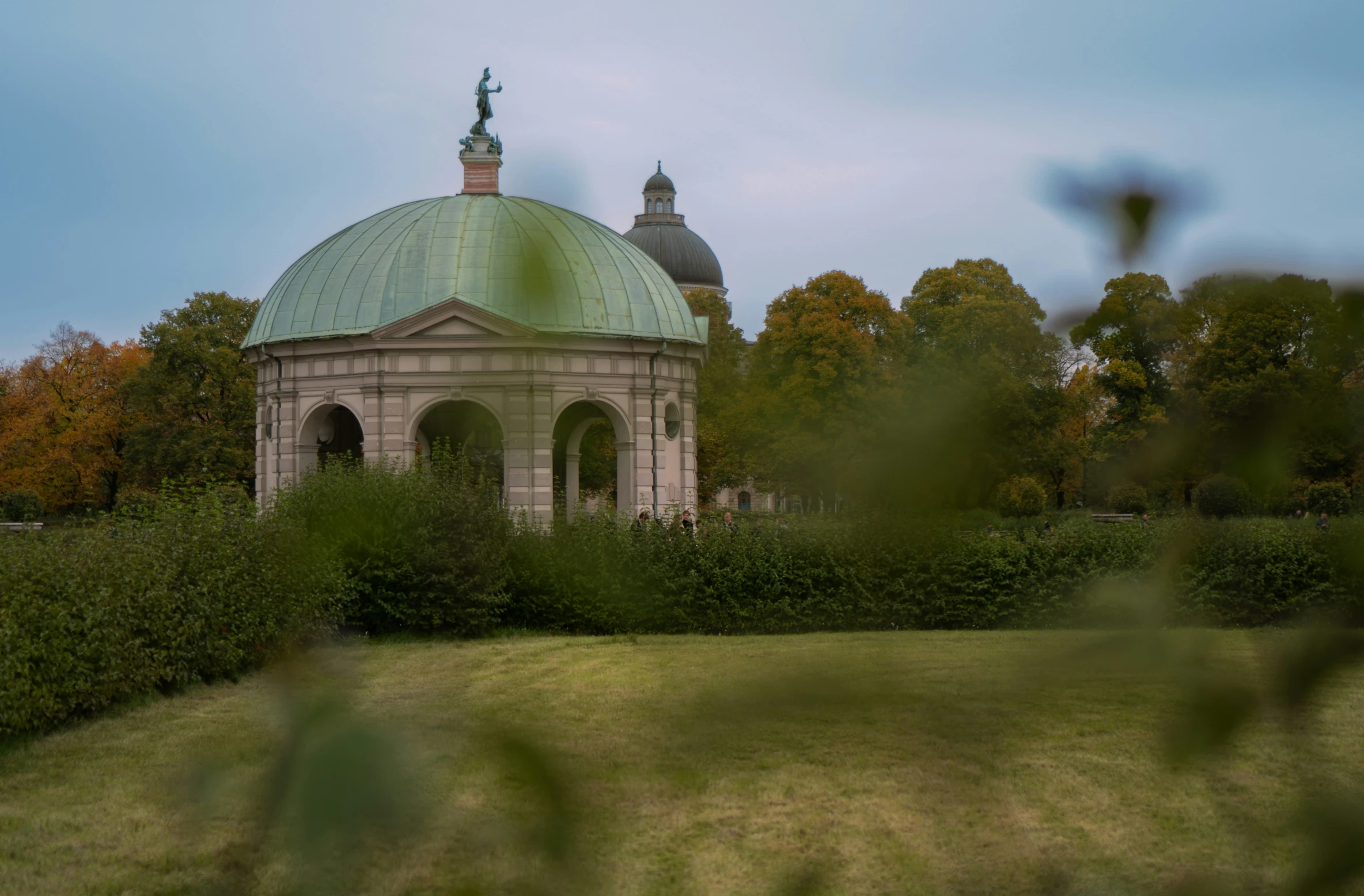 there is a building that is surrounded by greenery