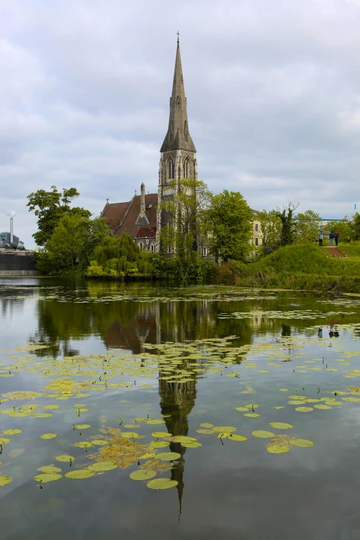 a large cathedral is reflected in the calm water