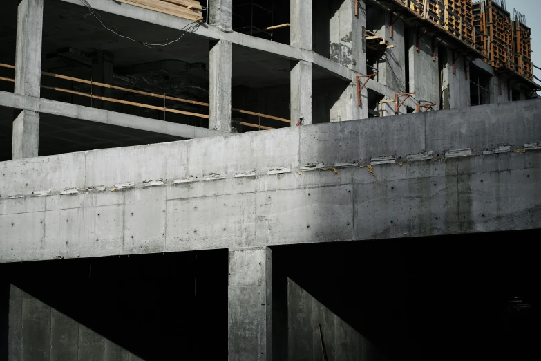 a view of a building under construction with two men on the roof