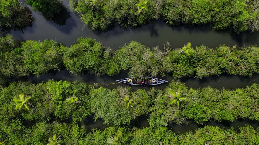 a man is on the canoe floating in the water