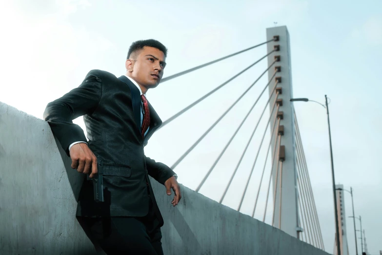 a man in a suit leaning on the wall