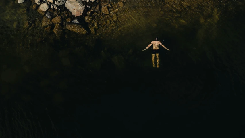 the person is floating in the water outside