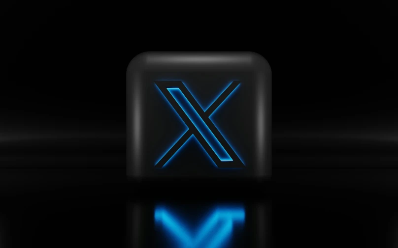 the blue alphabet x logo on top of a black background