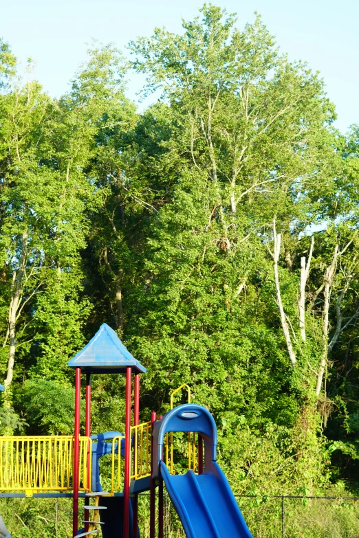 there is a slide, and a large playground in the park