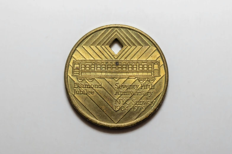 a gold medallion with an elaborate motif on it