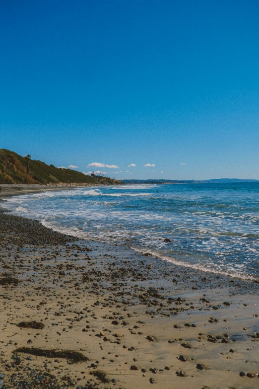 the tide rolls in on a sandy beach