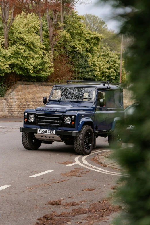 a black and blue vehicle driving down the road