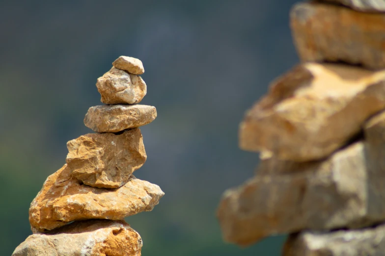 two rocks with a piece of rock stacked on top of each other