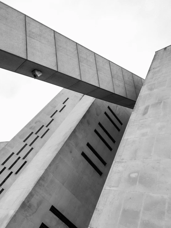 a close up of two cement structures against a gray sky