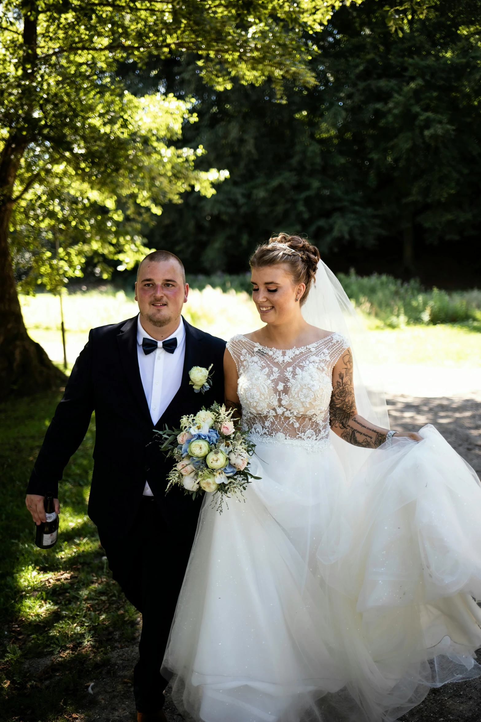 a man and woman wearing tuxedos walking away from each other