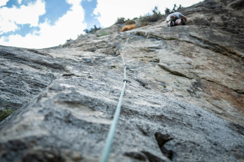 someone is climbing up and down a rocky mountain