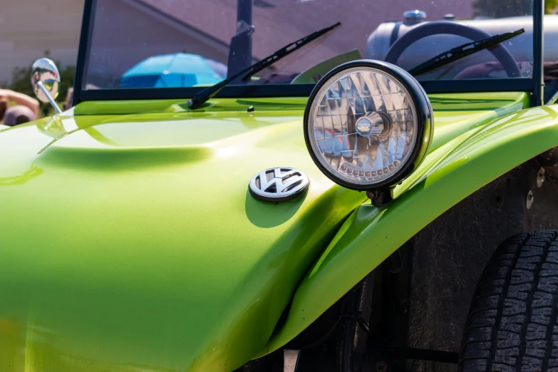 a light on the front of a bright green jeep