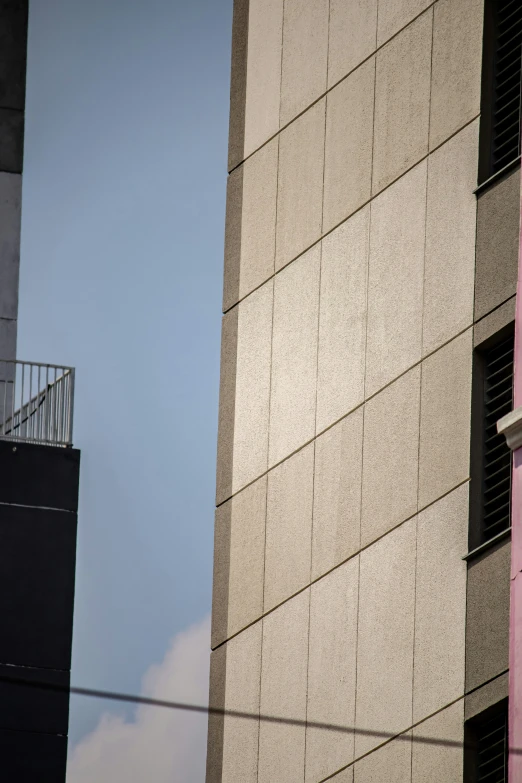 two buildings side by side one is pink and the other is blue