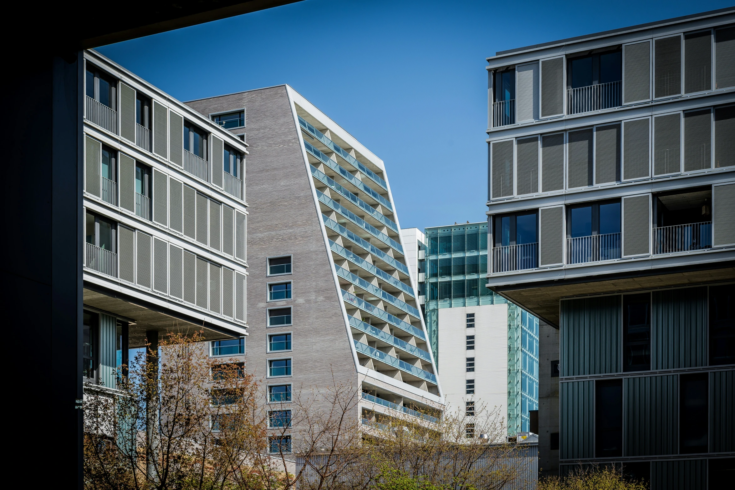 buildings with balconies sit in the middle of a city