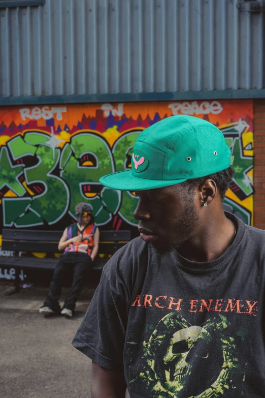 a man wearing a green hat is standing