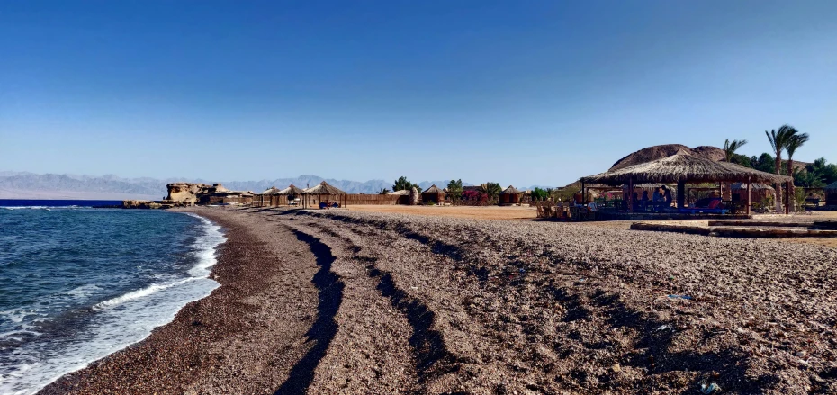 an empty beach is shown on a sunny day