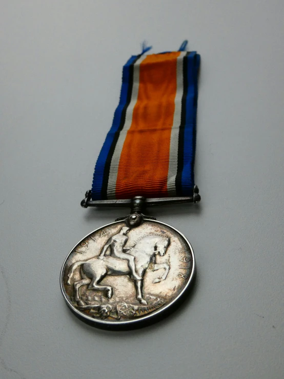 a coin with a medal that has a horse design on it