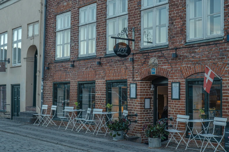 a couple of chairs that are sitting in front of a building