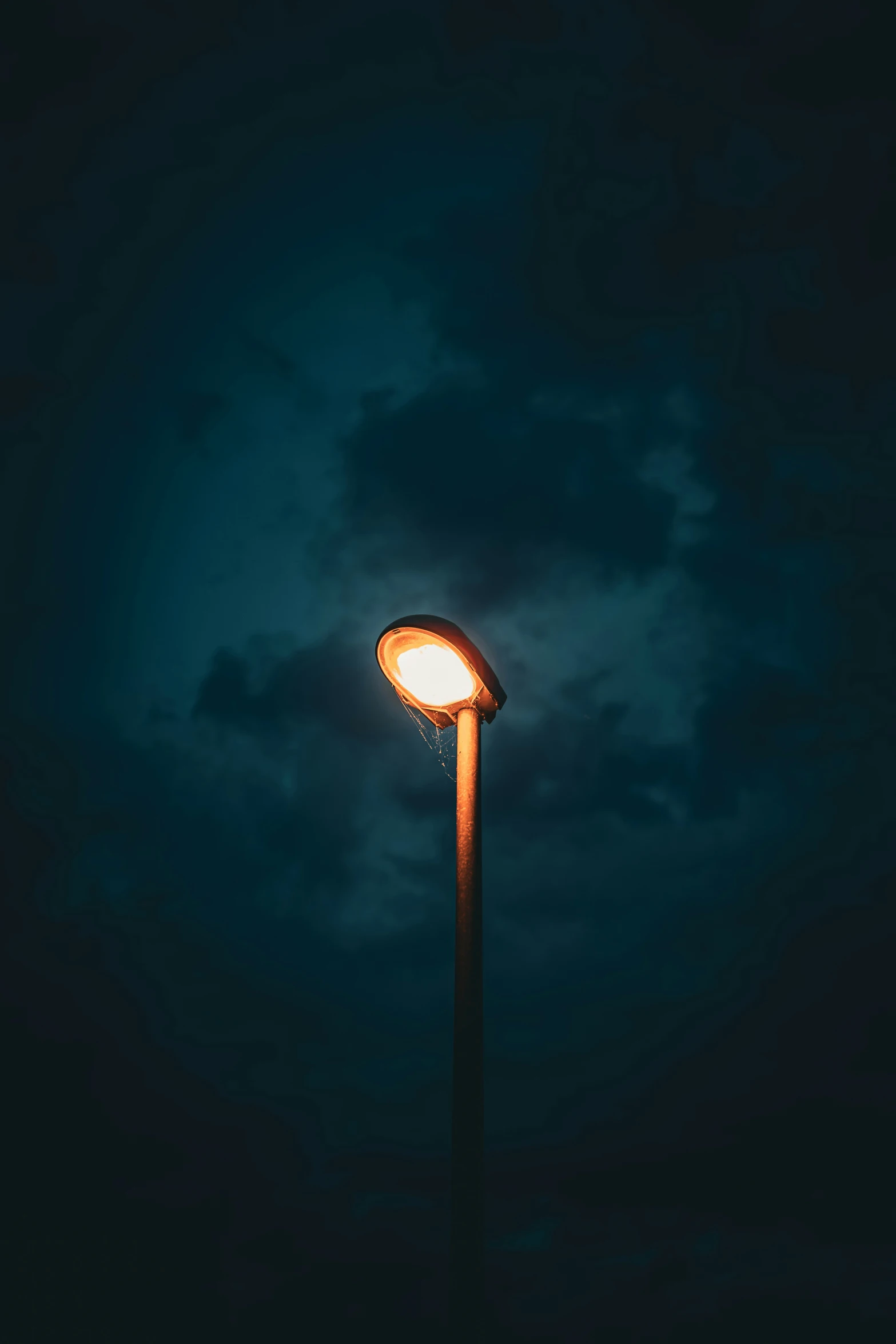 a street light at night lit by a single street lamp