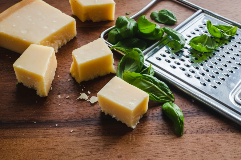 four slices of cheese sitting on top of a  board