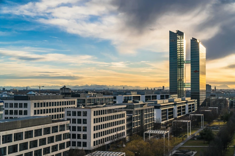 the view of some skyscrs against a partly cloudy sky