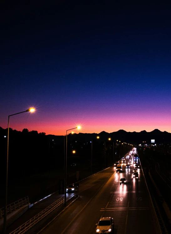 a street filled with lots of traffic at night