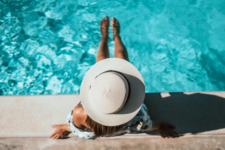 a person that is laying down with a hat on