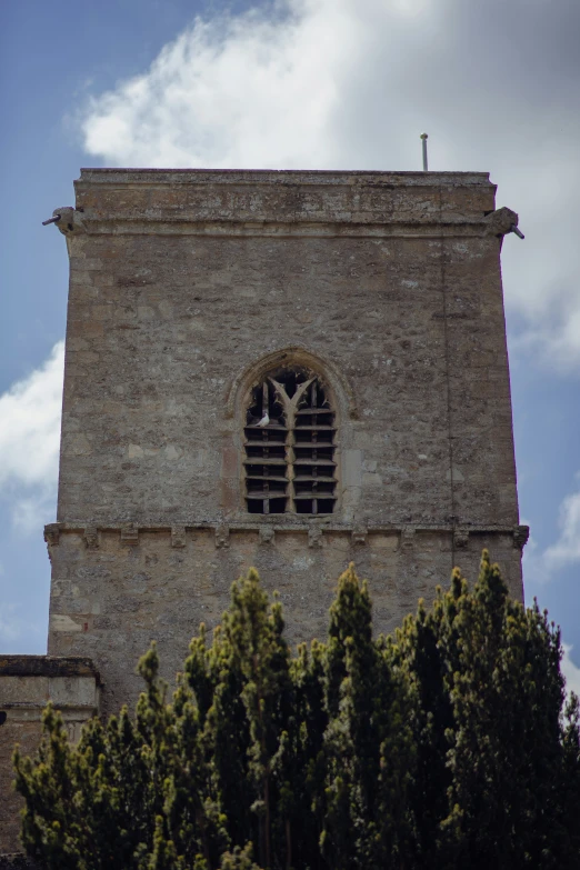 the large brick tower has two small windows