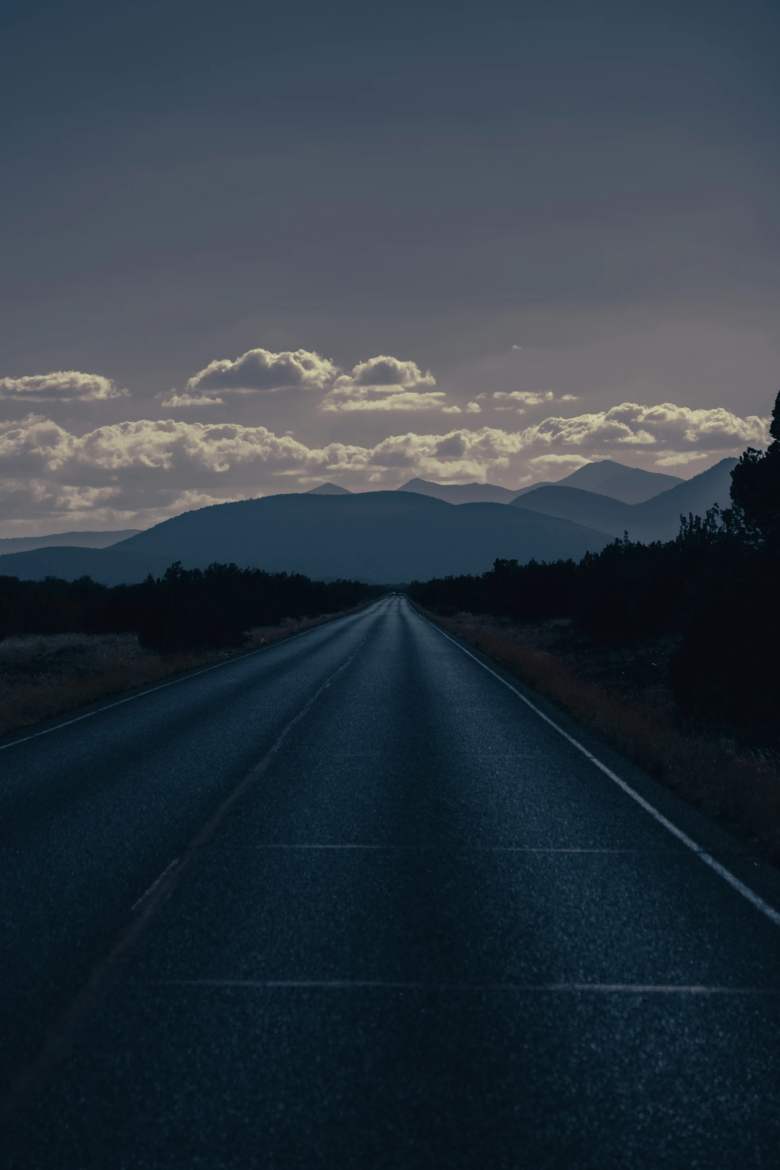 a road at dusk with no cars or people on it