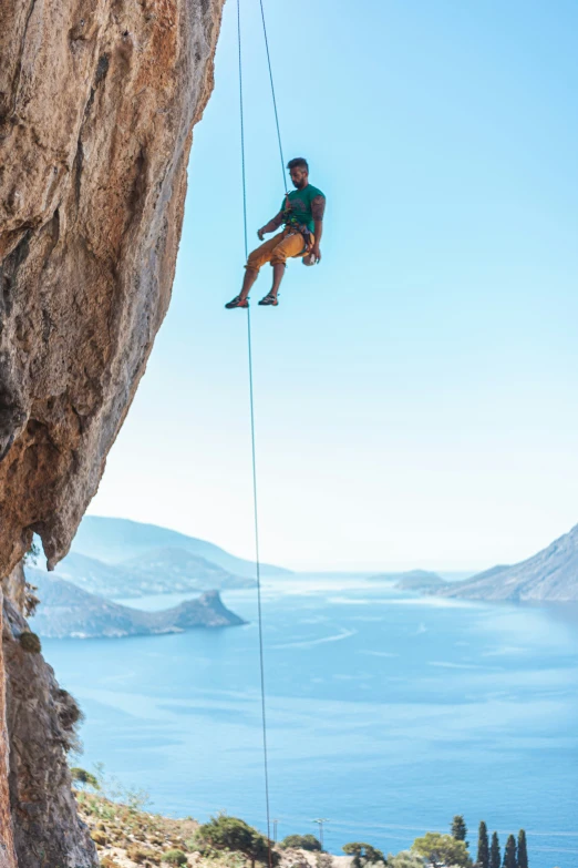 the climber is attempting to jump from rope on the cliff