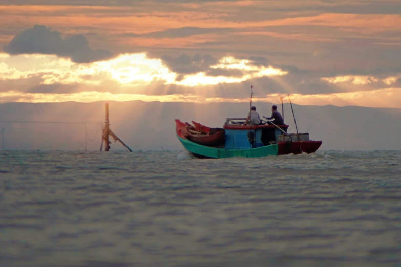 a couple of men sit on the front of a boat