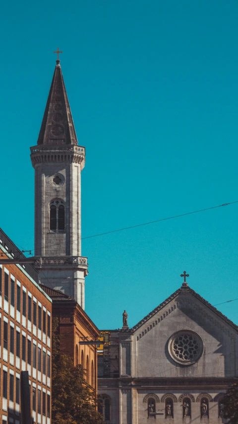 church with bell tower surrounded by tall buildings