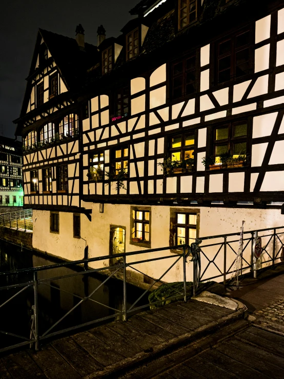 some buildings on the side of the street at night