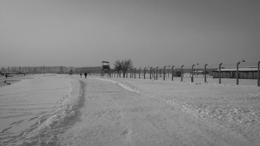 there are many street lamps and benches in this snowy field