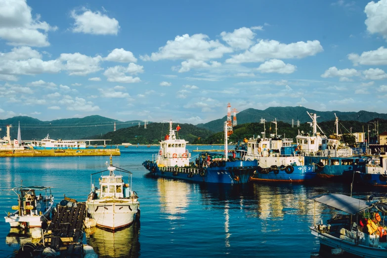 a harbor filled with lots of blue boats and docked ships