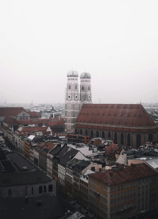 the city has many large buildings and a tall church in the background