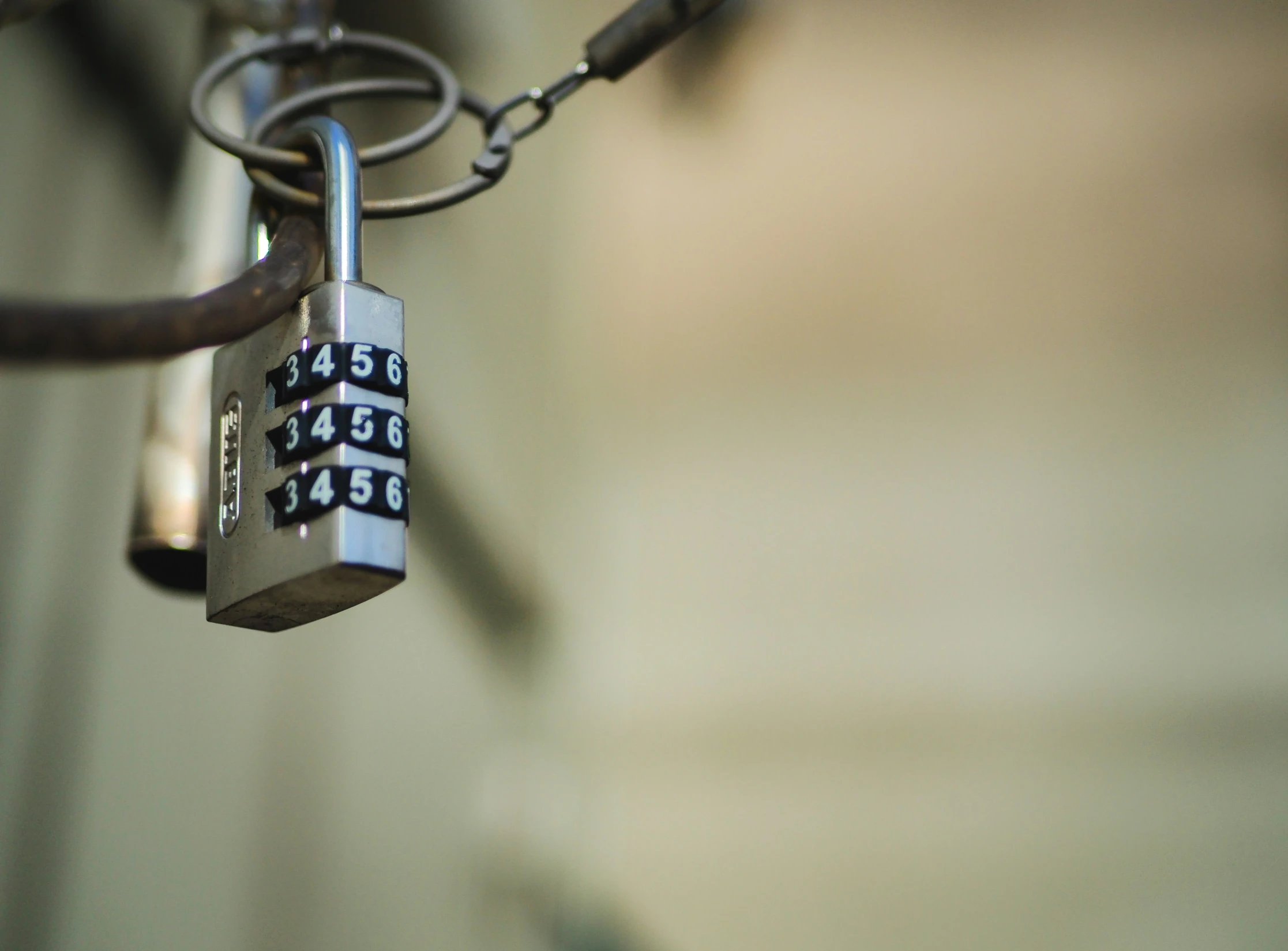 two locks and chains attached to a gate