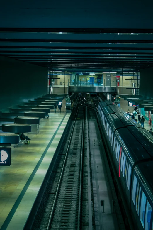 many people wait for a train at the station