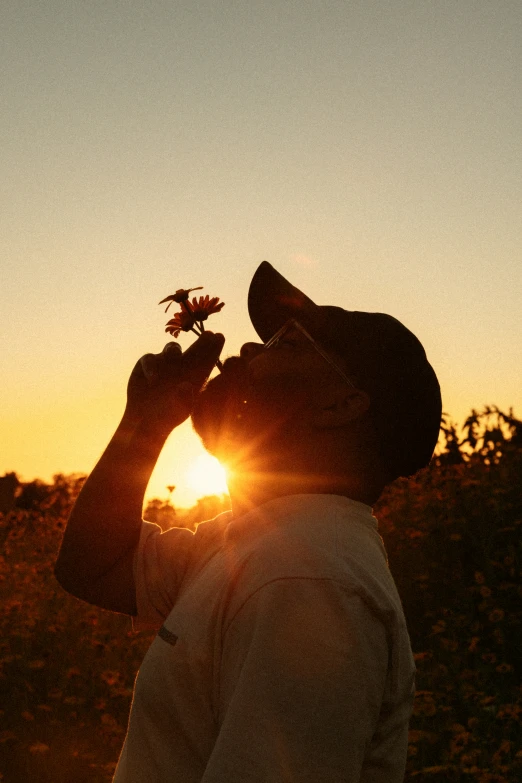 a person is taking a picture of the sun at sunrise