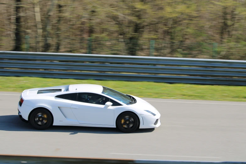 the sports car drives on the highway during daytime