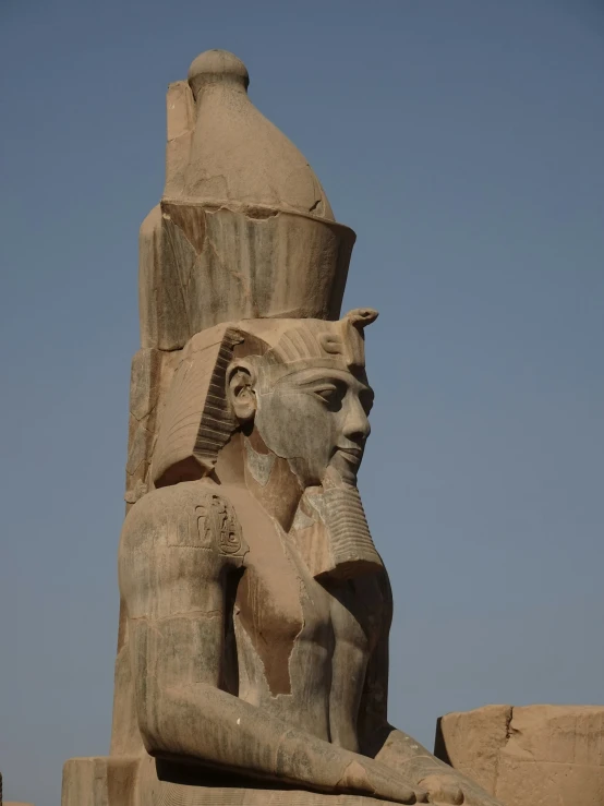 a big stone sculpture with a man holding another statue